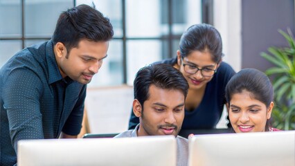 Fototapeta premium Indian professionals working together as a team in an open office environment. 
