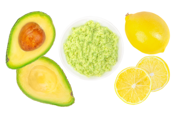 Avocado cream in bowl of guacamole green paste of mashed avocados and lemon isolated on white background. Top view