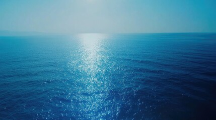 Obraz premium A clean, abstract blue sea gradient background with shimmering effects and no defined horizon.