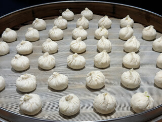 many Chinese Baozi uncooked in steamer