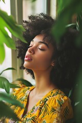 A woman with curly hair is wearing a yellow floral dress