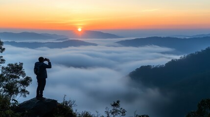 Fototapeta premium Sunrise Photographer on Mountaintop above Misty Valley Landscape