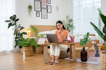 Young asian university woman doing homework at home