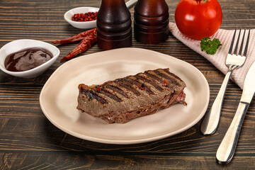 Grilled beef striploin steak with sauce