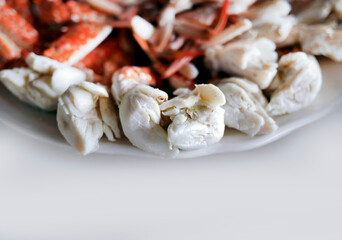 Steamed peeled blue swimming crab serving with Thai spicy chilli sauce, enjoying seafood meal from the sea, local restaurant, isolated