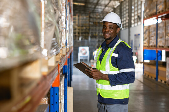 african black professional warehouse worker. stock inventory staff employee working in cargo storage