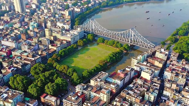 Stunning Aerial View of Kolkata, Iconic Howrah Bridge Over the Hooghly River, Surrounded by Lush Greenery and Bustling Urban Landscape