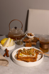 Breakfast with cream cheese toasts and caramelized pears, honey and walnuts