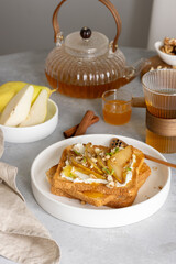 Breakfast with cream cheese toasts and caramelized pears, honey and walnuts