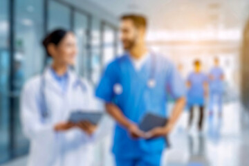 Fototapeta premium blurred for background. blurred figures of doctors and nurses in a hospital corridor. Doctors and nurses walking in hospital hallway. blurred motion. Moving human figure in the clinic corridor