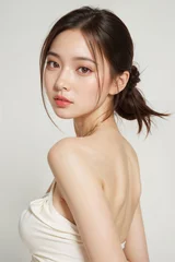 A woman with a ponytail and a white shirt