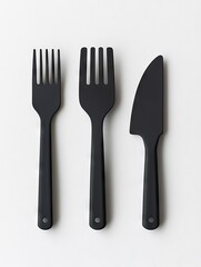 Black cutlery set on white background; simple food prep