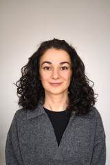 An isolated woman's portrait looking straight forward and smiling