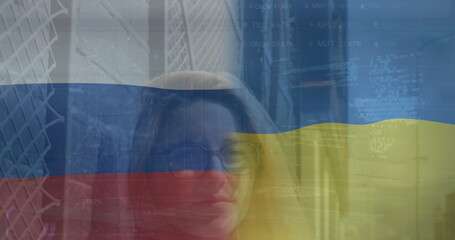 Image of flags of russia and ukraine over caucasian woman in city street