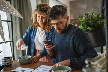 man is having breakfast and scan QR code from invoice to make payment