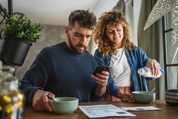 man is having breakfast and scan QR code from invoice to make payment