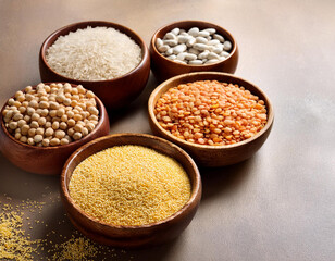 Bowls with different cereals on wooden background