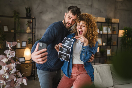 couple announcing their pregnancy to family during a video call