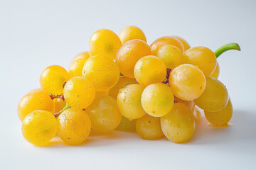 Yellow grapes are clustered together on a white background, showcasing their sweet and juicy texture. The bright color invites a refreshing taste, perfect for healthy snacking or fruit salads.