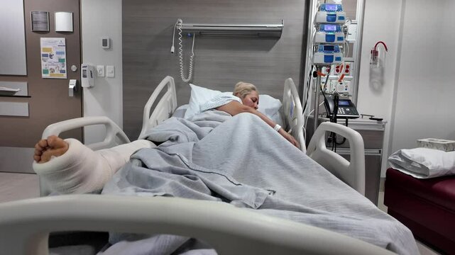 A woman is in a hospital bed with a cast on her leg