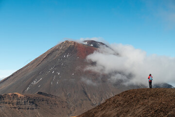Female hiker enjoying the spectacular view of Mount Ngauruhoe as spotted during the Tongariro Crossing (North Island, New Zealand) 
