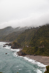 View of western shoreline of Nea Zealand's South Island as seen after a rainshower with crashing waves and rolling clouds (New Zealand)