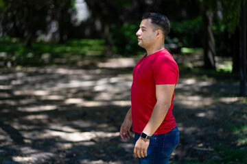 Attractive young man in profile in a park