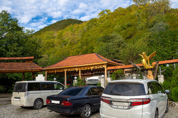 Fototapeta premium Traditional chalet with a rest area and a bar for tourists to visit when climbing a mountain gorge. Foothills of the Caucasus, Abkhazia