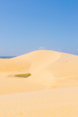 Sand dunes in Paracuru, like a desert with sea in the background. Ceara, Brazil.