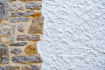 An old stone wall and white wall as background