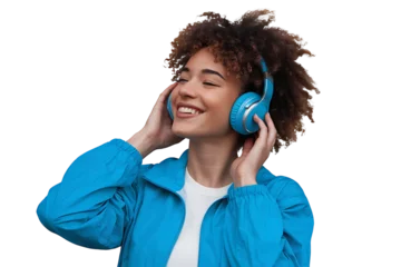 Fotobehang Joyful young woman listening to music with blue headphones, wearing a vibrant blue jacket isolated on transparent background  © Athena 