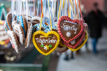 Traditional gingerbread heart cookies hanging from the eaves of a Christmas Market booth in Austria