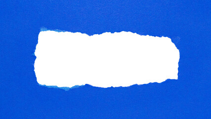 Blue torn paper or cardboard message backdrop with rough edges and blank copy space for text in the...