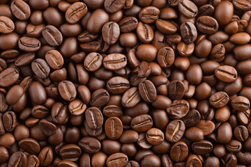 Dark roasted coffee beans arranged on a surface, showcasing their rich texture and color