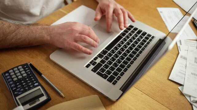 financial calculations accounting. a man keeps home accounting, calculates the family budget, works with taxes, documents, sitting at home in a cozy environment. High quality FullHD footage