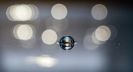 Water drop reflections on smooth surface with bokeh light effects