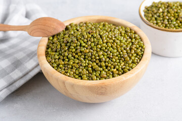 Mung beans in a bowl on light background. Healthy plant-based protein, healthy cooking ingredient for vegan recipes and vegetarian diets, close up