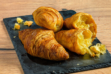 Flaky Croissants on a Black Slate Board