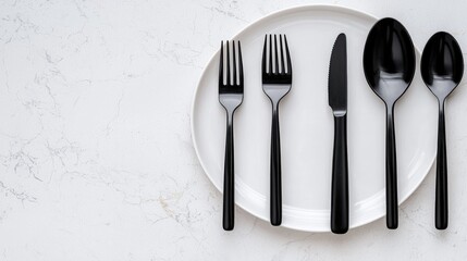 Black cutlery on white plate, marble background; table setting, food photography, restaurant