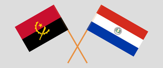 Crossed flags of Angola and Republic of Paraguay. Official colors. Correct proportion. Vector illustration