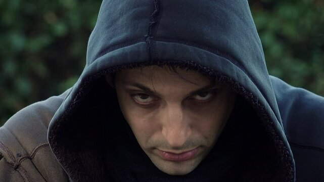 dramatic and criminal portrait: psychopathic look, desperate young man