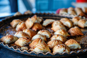 Uzbek Samsa or Sambousak oriental meal stuffed with meat, cheese or vegetables at street market bazar in Samarkand or Bukhara, Uzbekistan