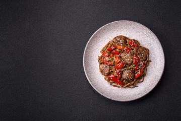 Delicious spicy Asian food soba with buckwheat noodles, beef, vegetables