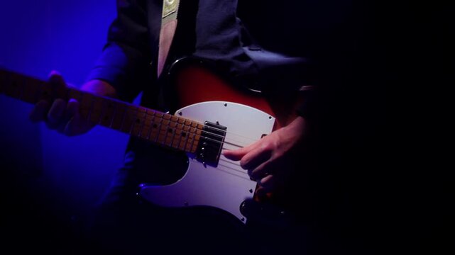 guitarist playing a vintage left hand fender telecaster during a concert