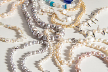 Pearl jewelry on white background. Necklace or bracelet. Different types of natural pearls