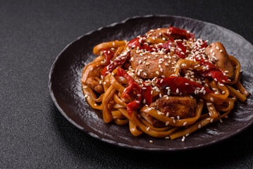 Delicious Asian food udon with noodles, chicken, hot pepper, vegetables