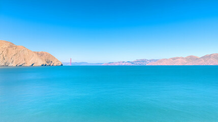 Fototapeta premium Golden Gate Bridge distant view, calm ocean, clear sky, coastal mountains, travel postcard