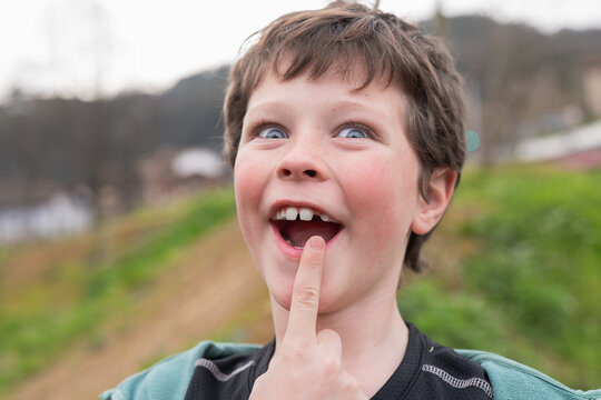 Young boy displays joy and curiosity in an outdoor setting in bike day