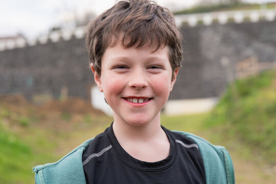 Cheerful young boy smiling outdoors in bike day