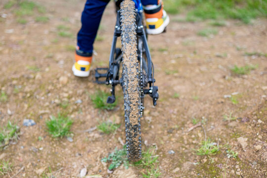 Muddy Bicycle Tire Traversing a Dirt Path in Adventure